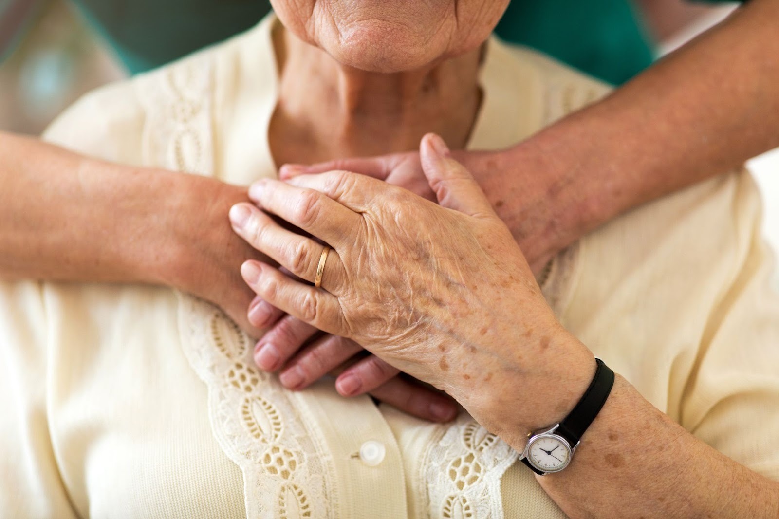 a senior being embraced from behind in support